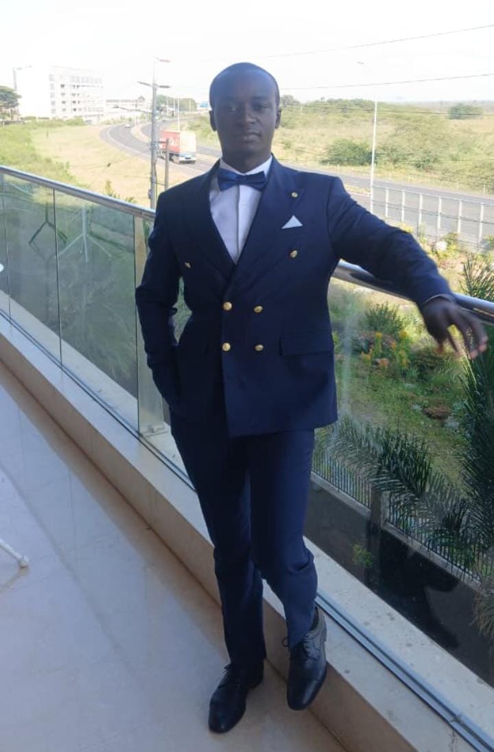 Calvince dressed in a navy suit